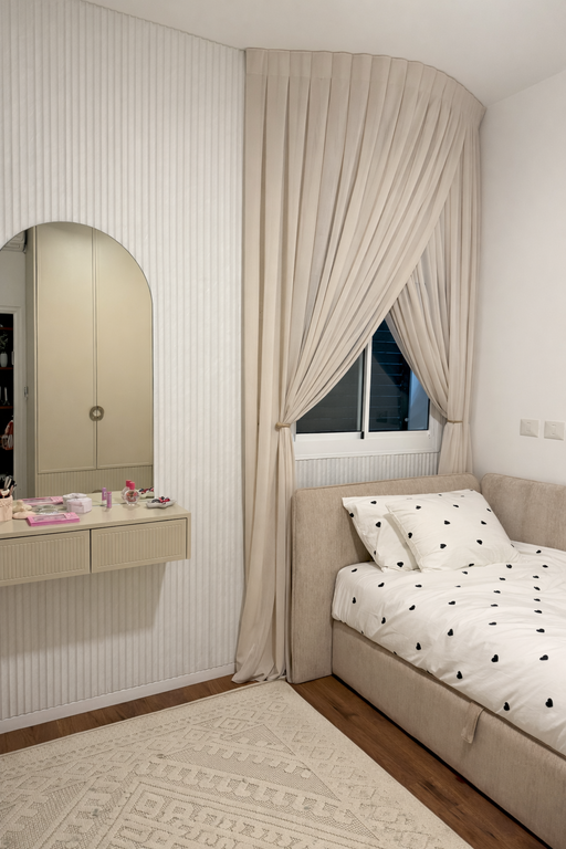 וילונות לחדר שינה של נערה בגוון שמנת עם קשירה דקורטיבית בצדדים מעל מיטה מעוצבת.